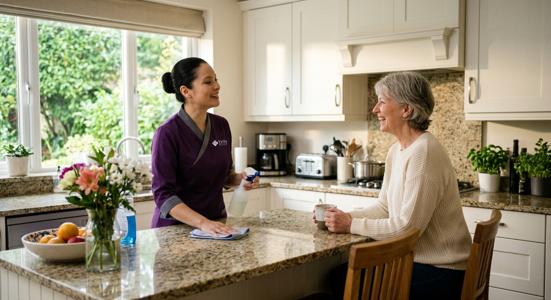 Maid visa in Dubai: domestic helper assisting a senior woman in a bright kitchen.