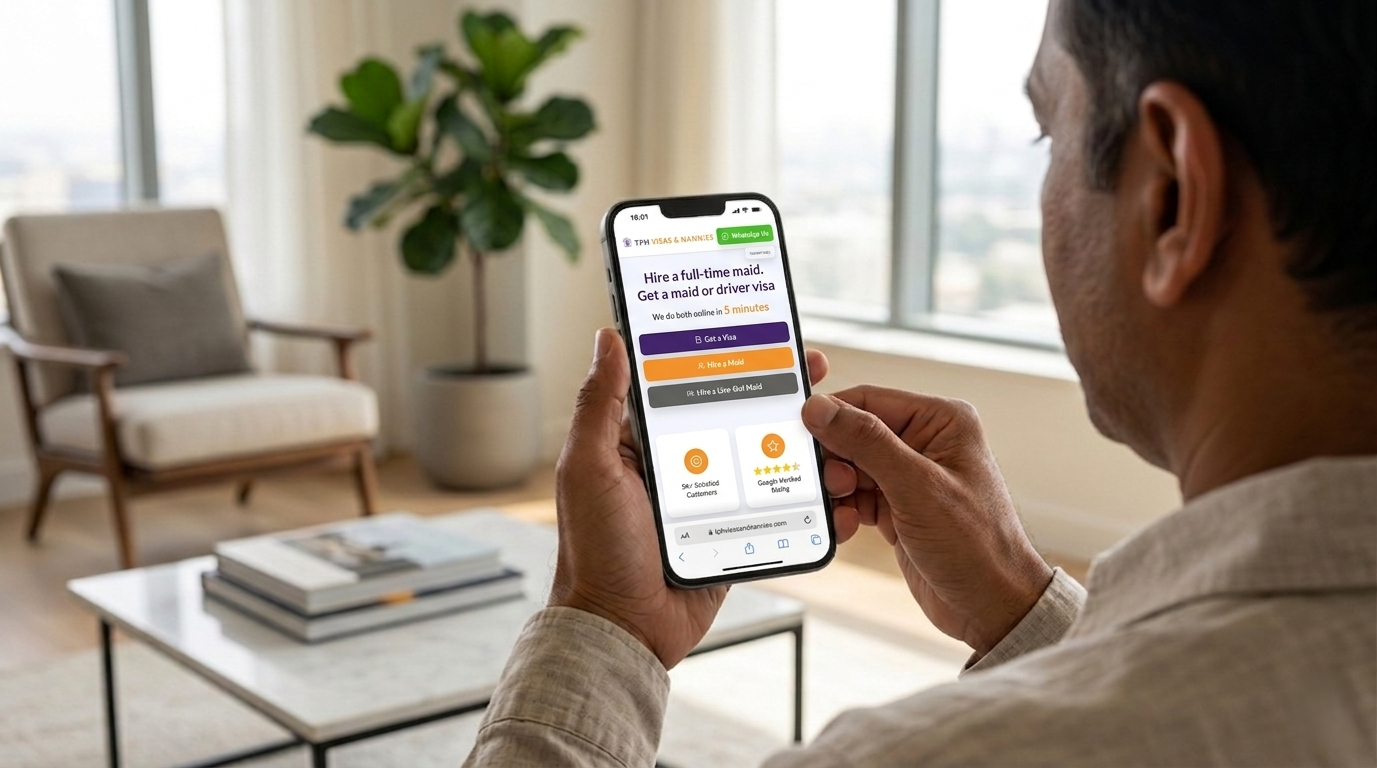 Man using a smartphone at home to hire a maid in Dubai through an online agency platform.