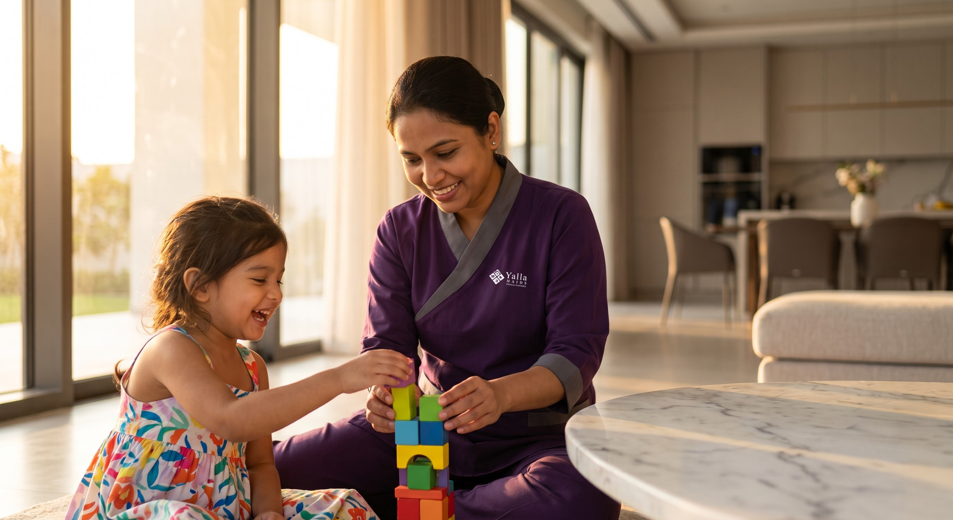 Nanny Dubai playing with a young child in a modern family home.